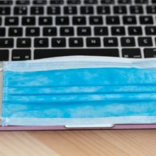 AV Header blue-and-white-face-mask-on-white-laptop-computer