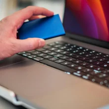Backup Header (2) man-hand-holding-disk-over-laptop