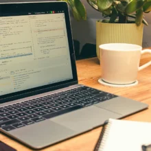 Planning a-laptop-computer-sitting-on-top-of-a-wooden-table