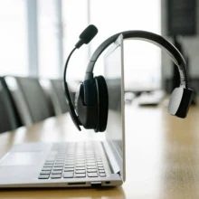 voip a-black-headset-microphone-hanging-on-the-laptop-screen