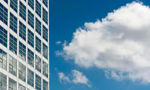 facade-of-a-modern-building-in-city-against-blue-sky-with-white-clouds