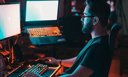 man-in-blue-shirt-using-computer