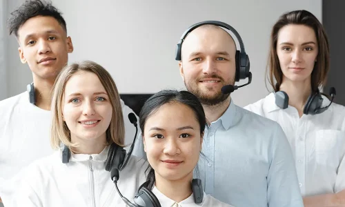 smiling-call-center-agents-looking-at-camera